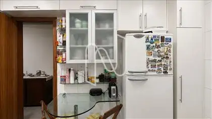 Cozinha com armários e mesa de apoio